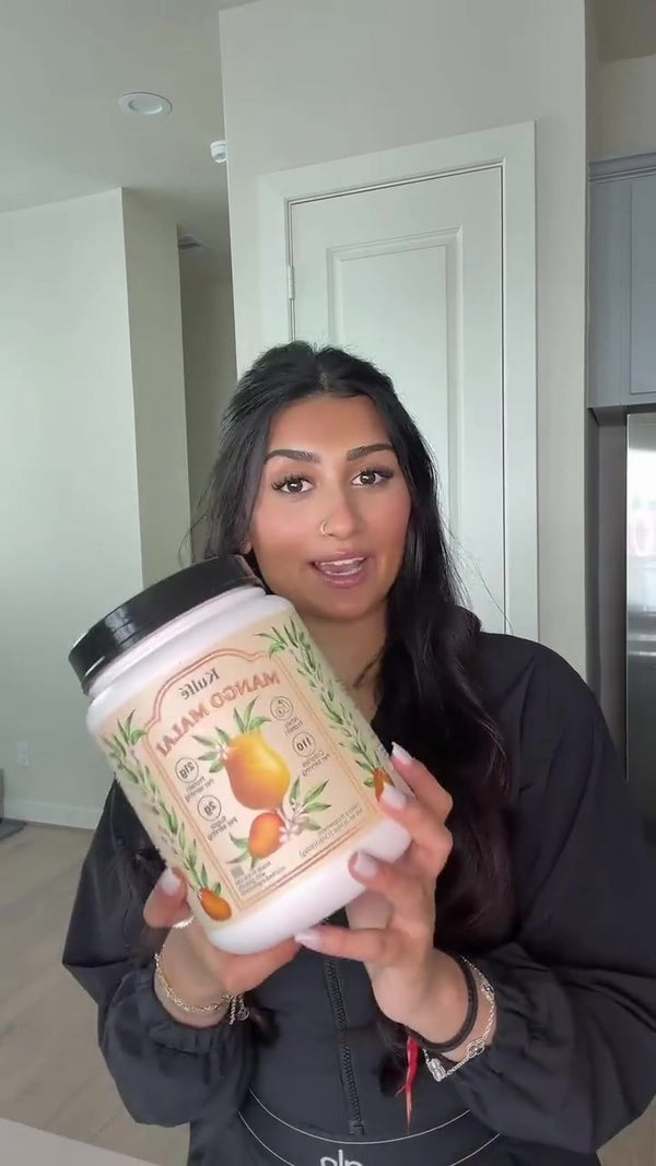 Customer holding a Mango Malai whey tub and milk